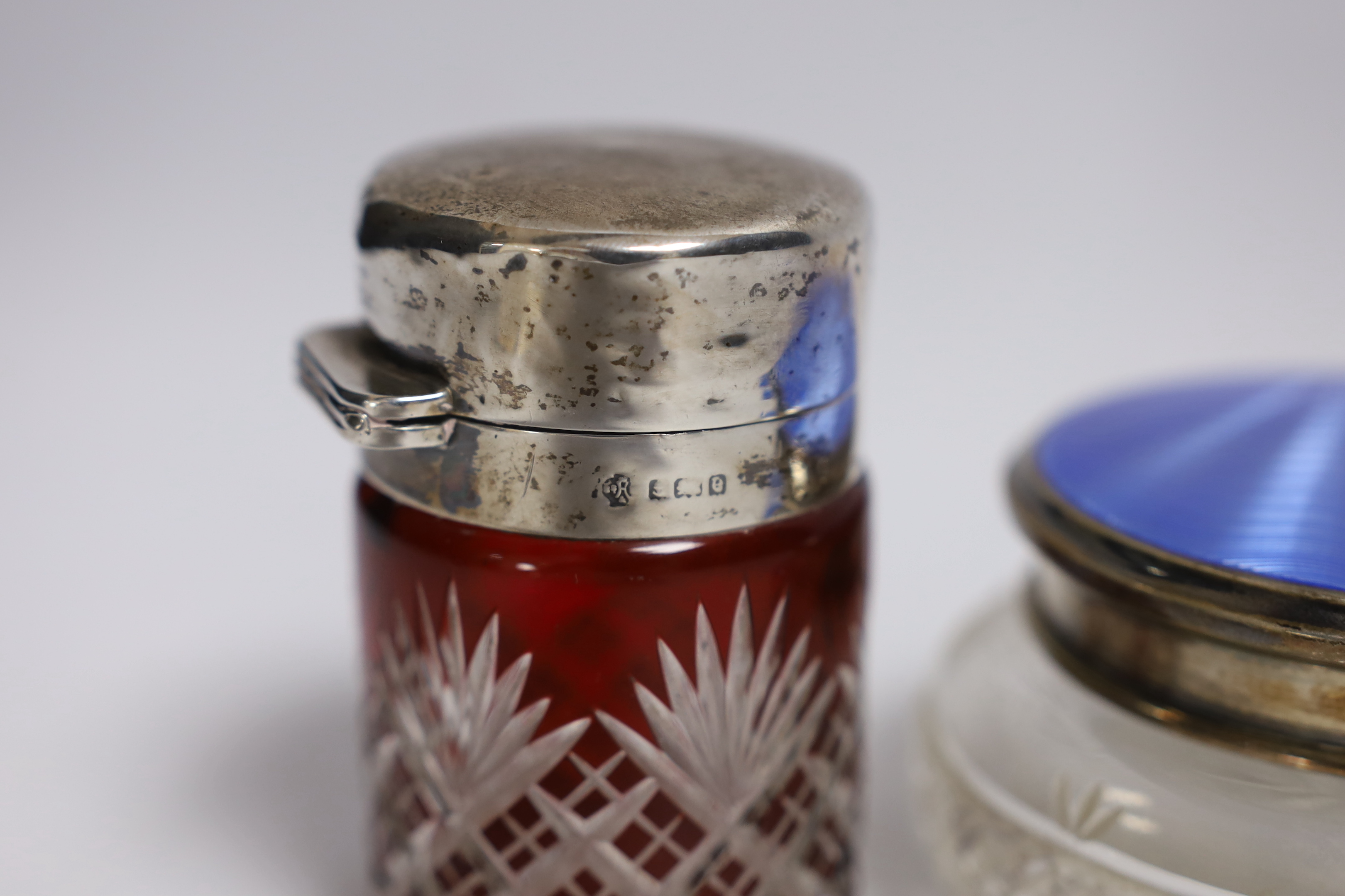 A silver and enamel compact, a silver and enamel mounted glass jar and an Edwardian silver mounted cut glass salts jar by William Hutton & Sons, Birmingham, 1904, 85mm.